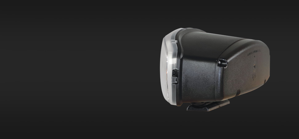 A sleek black electronic device with a clear front panel and a side switch, showcased against a dark gradient background.