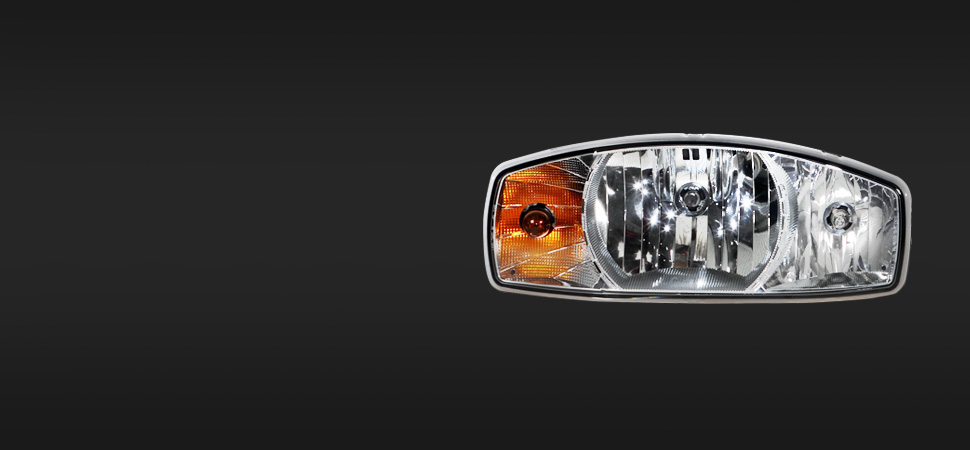 A close-up of a car headlight and turn signal assembly against a plain black background, highlighting the reflective surfaces and lens details for enhanced visibility.
